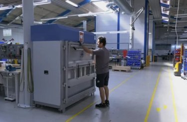 man operates baler in lean manufacturing facility